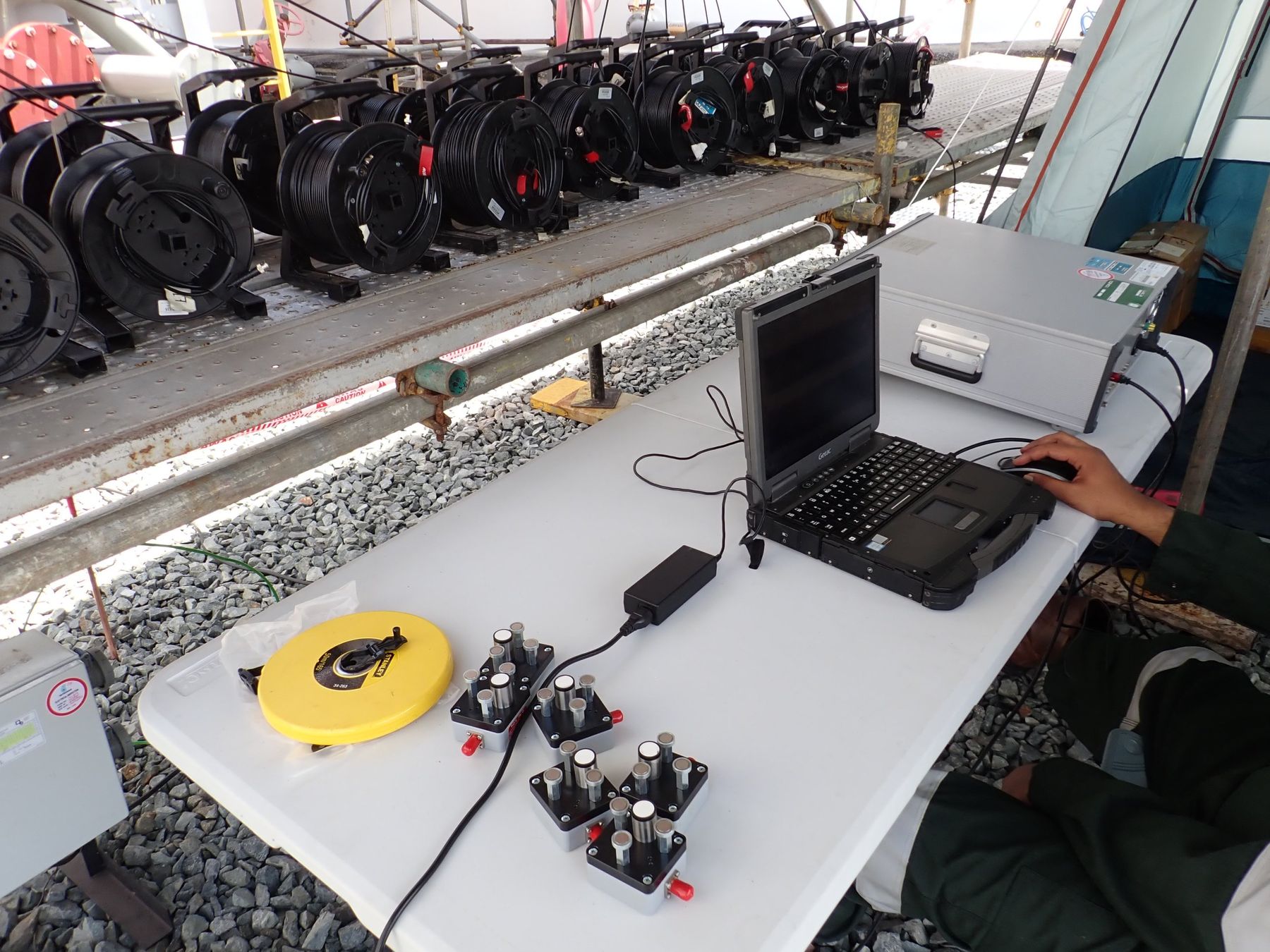Wavewurk Acoustic Emission acquisition setup with sensor cable reels and rugged field laptop on site
